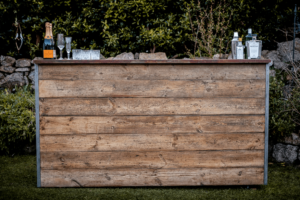 Wood bar with drinks sitting on top